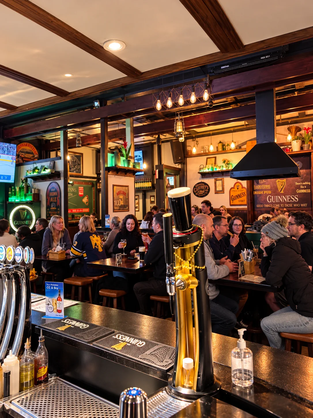 The busy bar interior at Lucky Finns with a Guinness tap in the foreground