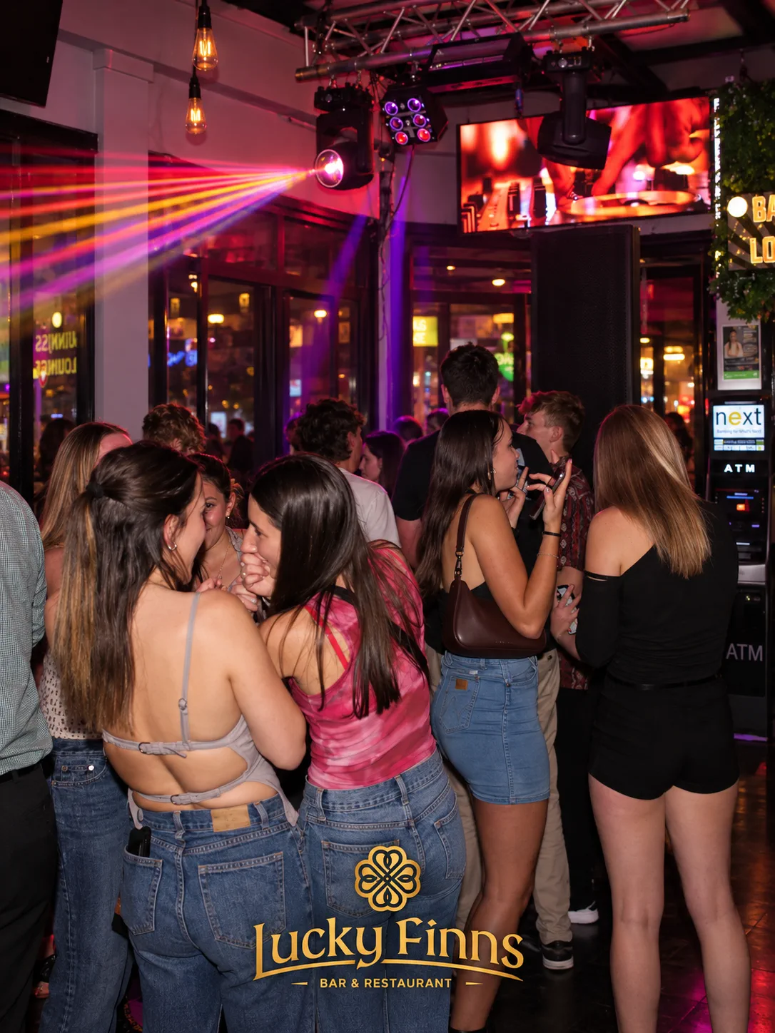 A lively evening with colorful lights and guests at Lucky Finns